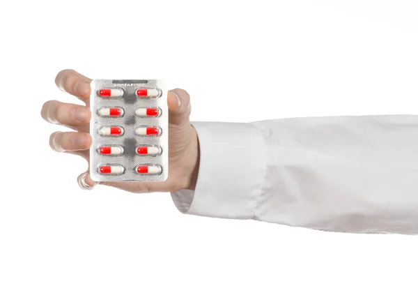 의료 주제: 의사의 손을 잡고 건강 흰색 배경에 고립에 대 한 빨간 캡슐 — 스톡 사진