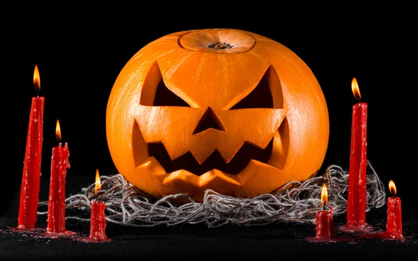 Eng pompoen, jack lantern, pompoen halloween, rode kaarsen op een zwarte achtergrond, halloween thema, pompoen moordenaar — Stockfoto