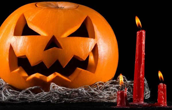 Scary pumpkin, jack lantern, pumpkin halloween, red candles on a black background, halloween theme, pumpkin killer — Stock Photo, Image