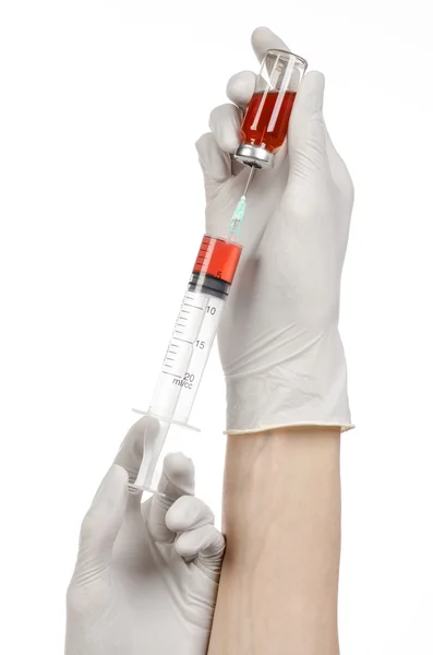 Medical theme: doctor's hand in a white glove holding a red vial of liquid for injection isolated on white background — Stock Photo, Image