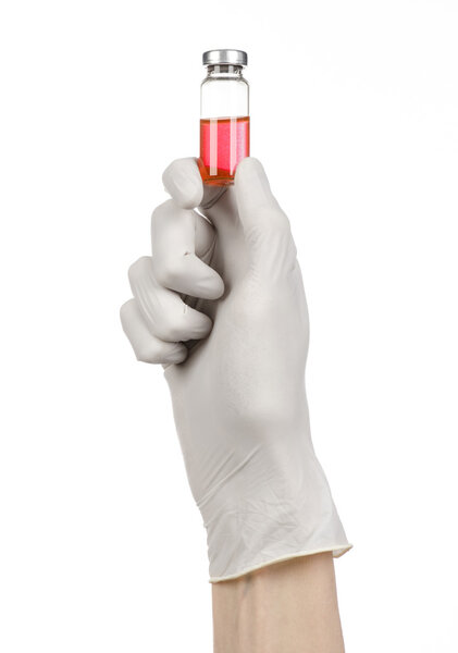 Medical theme: doctor's hand in a white glove holding a red vial of liquid for injection isolated on white background