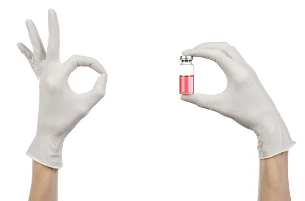 Medical theme: doctor's hand in a white glove holding a red vial of liquid for injection isolated on white background — Stock Photo, Image