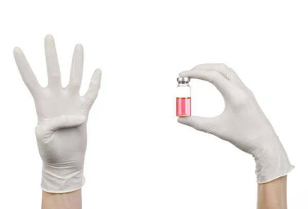 Medical theme: doctor's hand in a white glove holding a red vial of liquid for injection isolated on white background — Stock Photo, Image