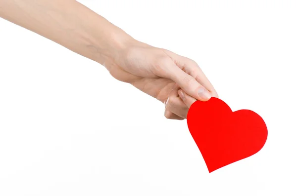 Valentine's Day and love theme: hand holding a red heart isolated on a white background in studio — Stock Photo, Image