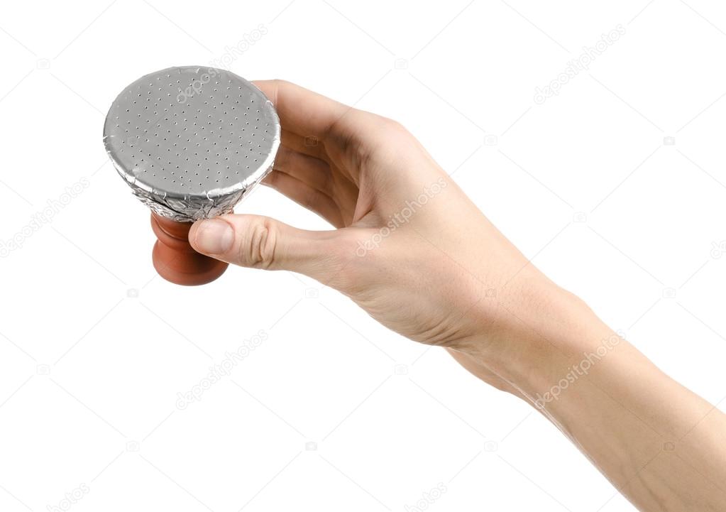 Bartender holding a clay bowl with tobacco for hookah covered with a foil with holes isolated on a white background