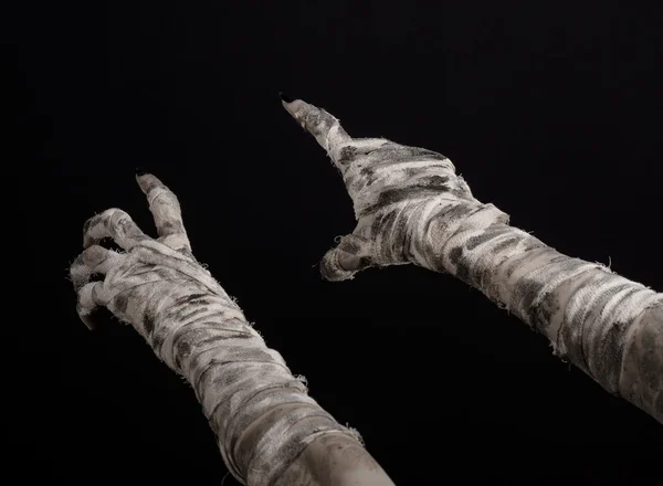 Halloween theme: terrible old mummy hands on a black background — Stock Photo, Image