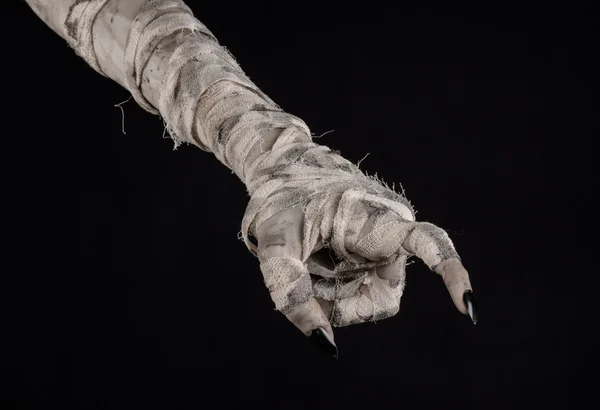 Halloween theme: terrible old mummy hands on a black background — Stock Photo, Image