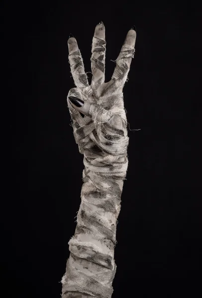 Halloween theme: terrible old mummy hands on a black background — Stock Photo, Image