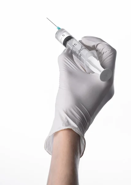 Doctor's hand holding a syringe, white-gloved hand, a large syringe, medical issue, the doctor makes an injection, white background, isolated, white gloves doctor — Stock Photo, Image