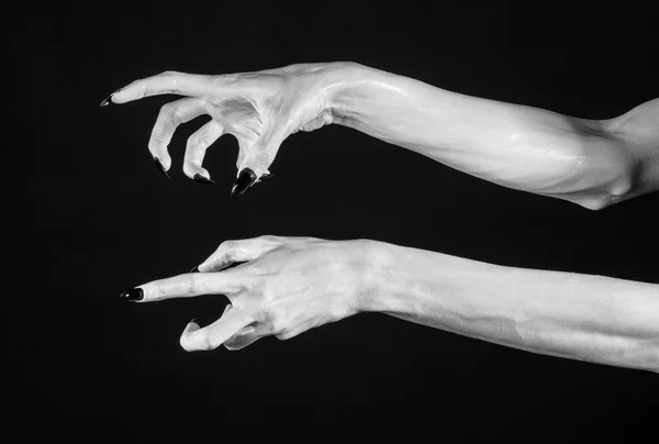 White hands of death with black nails, white death, the devil 's hands, the hands of a demon, white skin, halloween theme, black background, isolated — стоковое фото