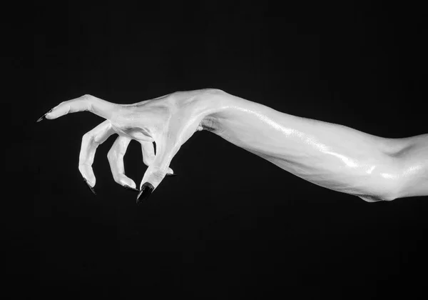 White hands of death with black nails, white death, the devil 's hands, the hands of a demon, white skin, halloween theme, black background, isolated — стоковое фото