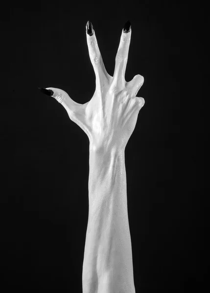 White hands of death with black nails, white death, the devil 's hands, the hands of a demon, white skin, halloween theme, black background, isolated — стоковое фото