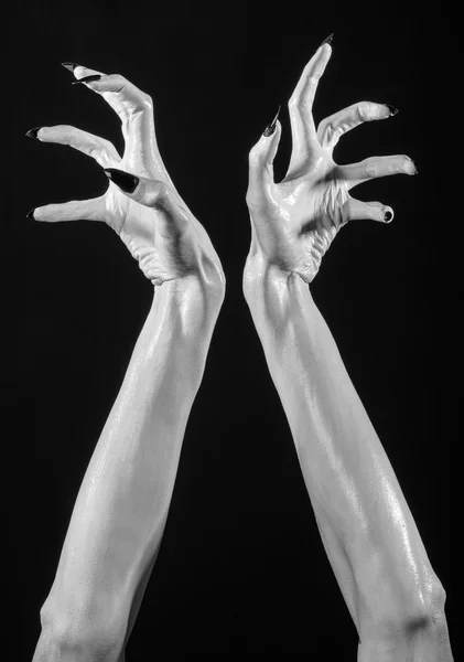 White hands of death with black nails, white death, the devil 's hands, the hands of a demon, white skin, halloween theme, black background, isolated — стоковое фото