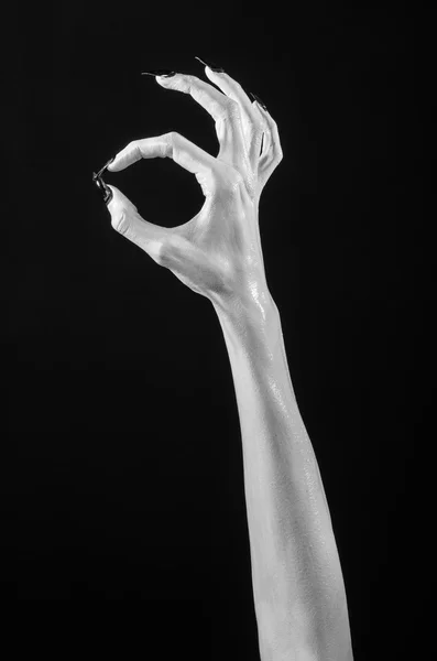 White hands of death with black nails, white death, the devil 's hands, the hands of a demon, white skin, halloween theme, black background, isolated — стоковое фото