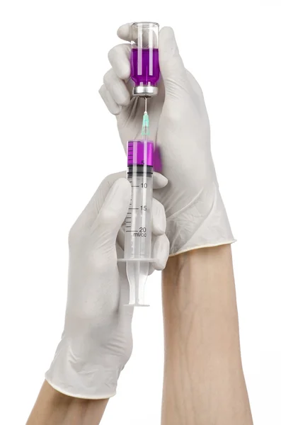 Medical theme: doctor's hand in a white glove holding a purple vial of liquid for injection isolated on white background — Stock Photo, Image