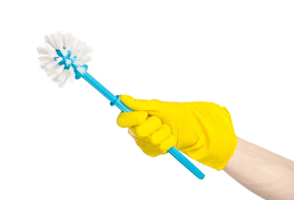 Cleaning the house and cleaning the toilet: human hand holding a blue toilet brush in yellow protective gloves isolated on a white background in studio — Stock Photo, Image