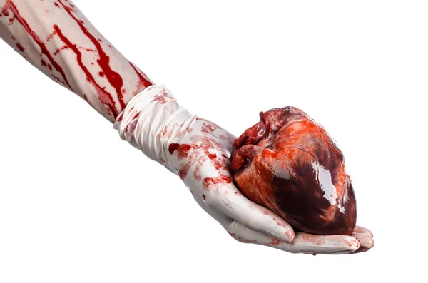 Operación y medicina tema: Cirujano sangriento de la mano sosteniendo un corazón humano en un sangriento guantes blancos aislados sobre un fondo blanco en el estudio — Foto de Stock