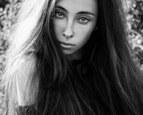 Dramatic portrait of a girl theme: portrait of a beautiful girl with flying hair in the wind in the forest — Stock Photo, Image