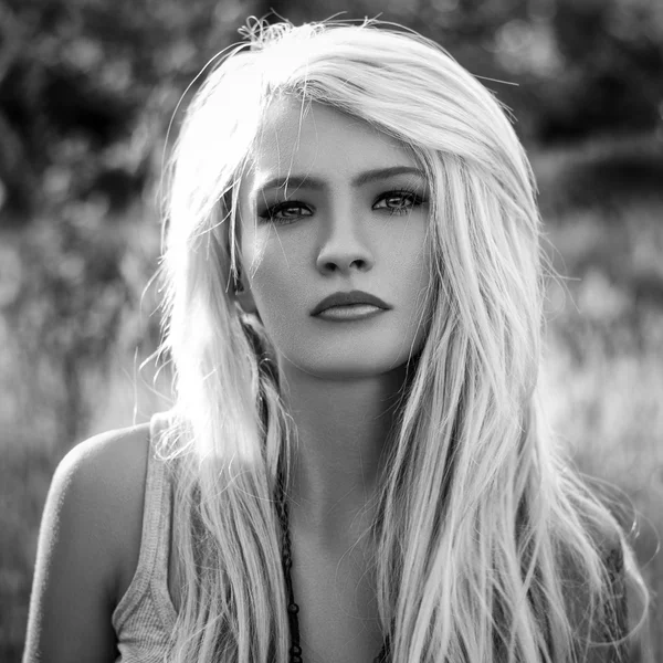 Dramatic portrait of a girl theme: portrait of a beautiful girl with flying hair in the wind in the forest — Stock Photo, Image