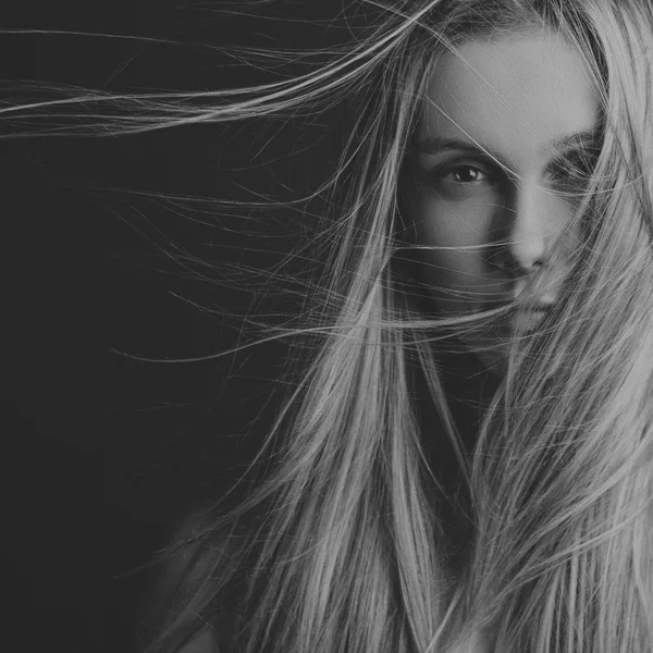 Retrato dramático del tema de una chica: retrato de una hermosa chica con el pelo volando en el viento sobre un fondo en el estudio —  Fotos de Stock