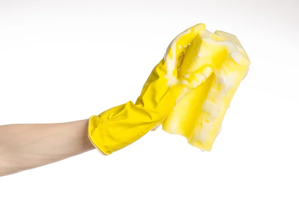 Cleaning the house and sanitation topic: Hand holding a yellow sponge wet with foam isolated on a white background in studio — Stock Photo, Image