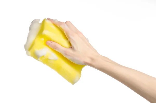 Cleaning the house and sanitation topic: Hand holding a yellow sponge wet with foam isolated on a white background in studio — Stock Photo, Image