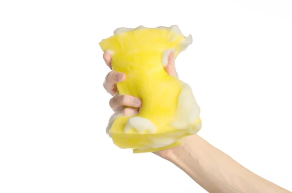 Cleaning the house and sanitation topic: Hand holding a yellow sponge wet with foam isolated on a white background in studio — Stock Photo, Image