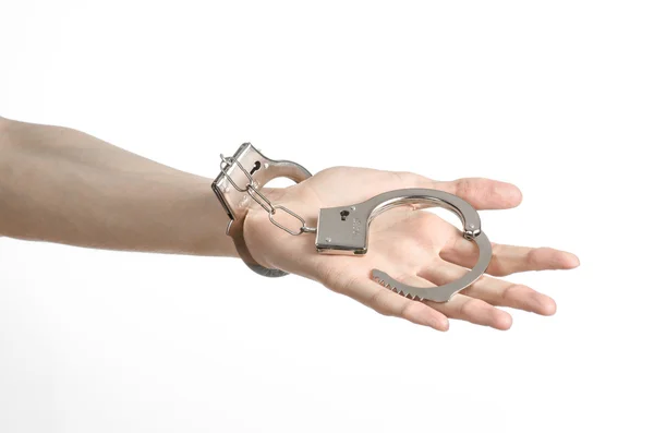 Prison and convicted topic: man hands with handcuffs isolated on white background in studio, put handcuffs on killer — Stock Photo, Image