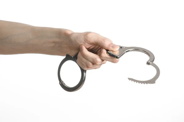 Prison and convicted topic: man hands with handcuffs isolated on white background in studio, put handcuffs on killer — Stock Photo, Image