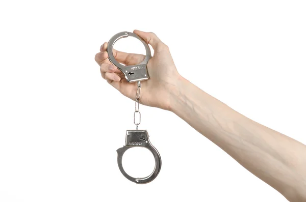 Prison and convicted topic: man hands with handcuffs isolated on white background in studio, put handcuffs on killer — Stock Photo, Image