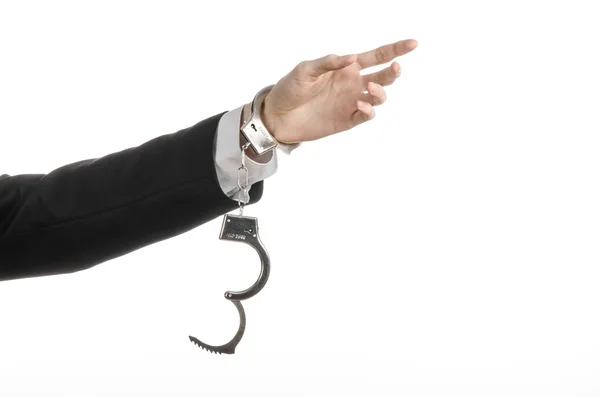 Corruption and bribery theme: businessman in a black suit with handcuffs on his hands on a white background in studio isolated — Stock Photo, Image