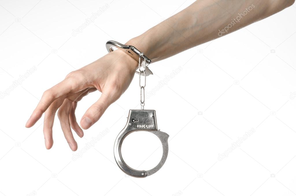 Prison and convicted topic: man hands with handcuffs isolated on