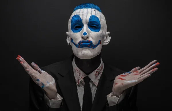 Terrible clown et thème Halloween : clown bleu fou en costume noir isolé sur un fond sombre en studio — Photo