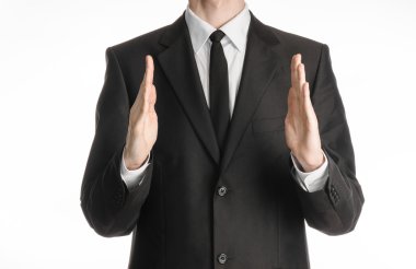 Businessman and gesture topic: a man in a black suit with a tie showing hands gesture on an isolated white background in studio