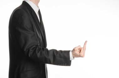 Businessman and gesture topic: a man in a black suit showing middle finger on an isolated white background in studio