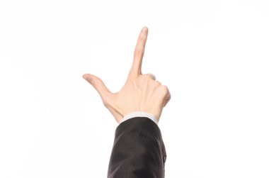 Gestures and Business theme: businessman shows hand gestures with a first-person in a black suit on a white background isolated