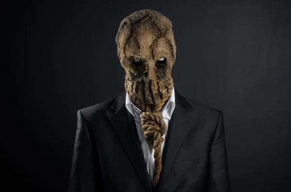 Fear and Halloween theme: a brutal killer in a mask on a dark background in the studio — Stockfoto