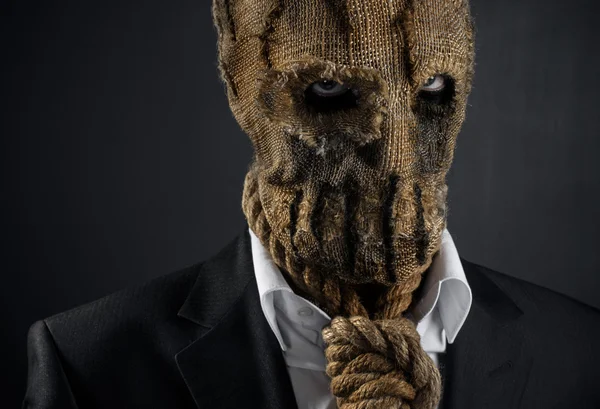 Fear and Halloween theme: a brutal killer in a mask on a dark background in the studio — Stok fotoğraf