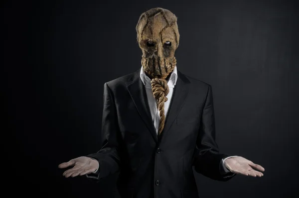 Angst und Halloween-Thema: ein brutaler Killer in Maske auf dunklem Hintergrund im Studio — Stockfoto