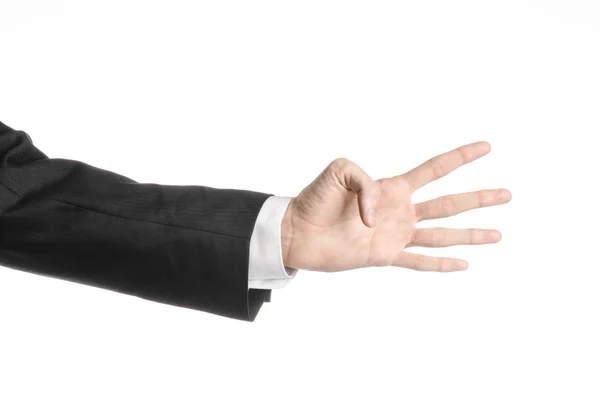 Businessman and gesture topic: a man in a black suit and white shirt showing hand gesture on an isolated white background in studio — Stock Photo, Image