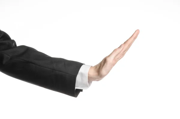 Предприниматель и тема жеста: мужчина в черном костюме и белой рубашке, показывающий жест рукой на изолированном белом фоне в студии — стоковое фото