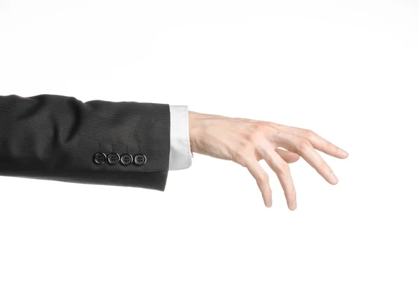 Hombre de negocios y tema del gesto: un hombre en traje negro y camisa blanca mostrando gesto de mano sobre un fondo blanco aislado en el estudio — Foto de Stock