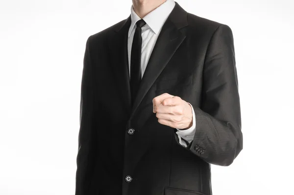 Businessman and gesture topic: a man in a black suit with a tie shows his hand forward isolated on white background in studio — 스톡 사진