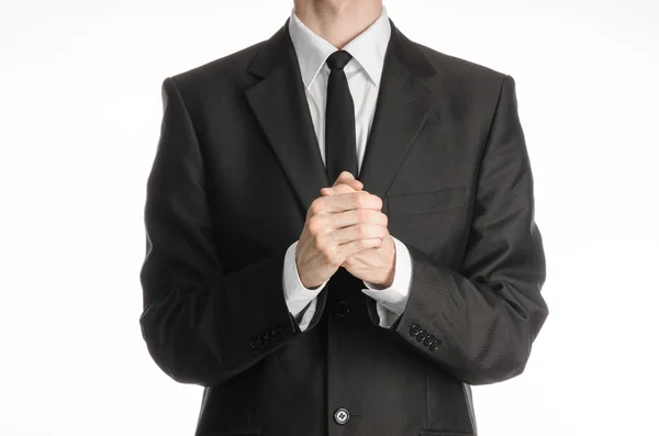 Businessman and gesture topic: a man in a black suit with a tie folded his hands in front of him and praying, meditating businessman isolated on a white background in studio — 스톡 사진