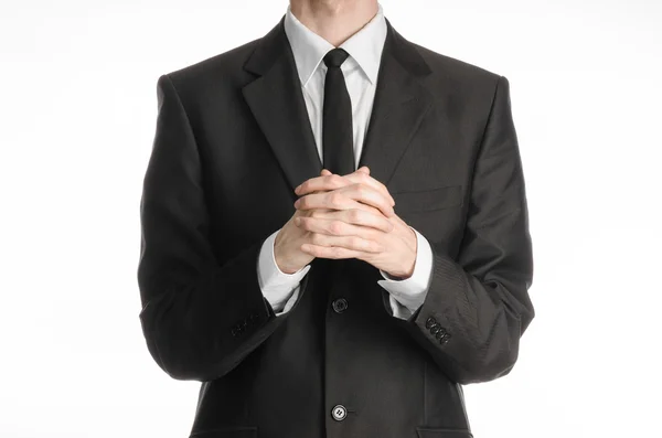 Businessman and gesture topic: a man in a black suit with a tie folded his hands in front of him and praying, meditating businessman isolated on a white background in studio — Stock Photo, Image