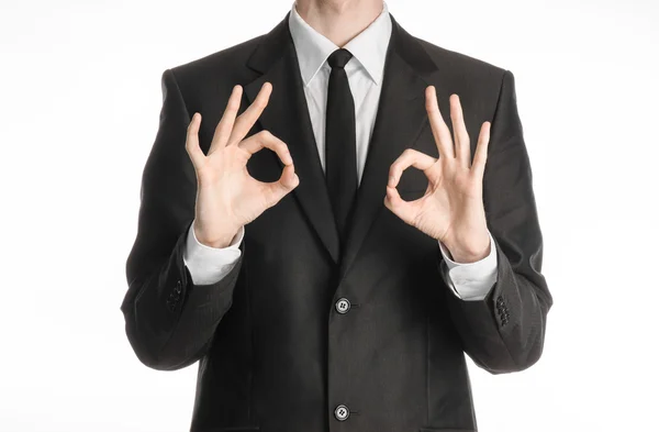 Businessman and gesture topic: a man in a black suit with a tie showing two hands sign of okay isolated on white background in studio — 스톡 사진