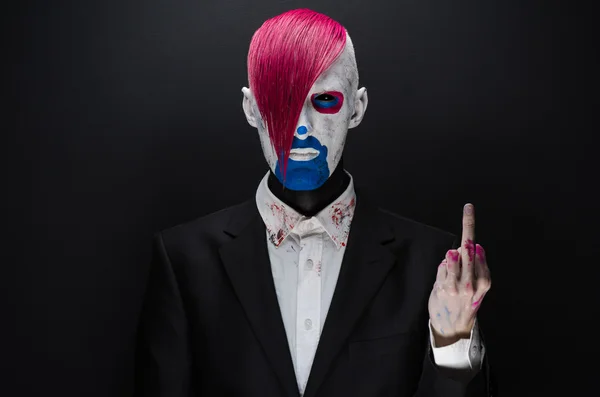 Clown and Halloween theme: Scary clown with pink hair in a black jacket on a dark background in the studio — Φωτογραφία Αρχείου