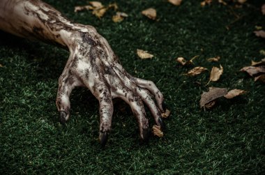 Korku ve Halloween Tema: korkunç zombi eller siyah çivi yalan yeşil çimen, yürüyen ölü kıyamet üzerine kirli, ana sayfa görünümü