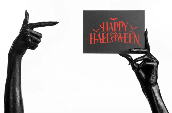 Postkarte und Happy-Halloween-Thema: Schwarze Hand des Todes hält eine Papierkarte mit den Worten Happy-Halloween auf weißem, isoliertem Hintergrund im Studio — Stockfoto