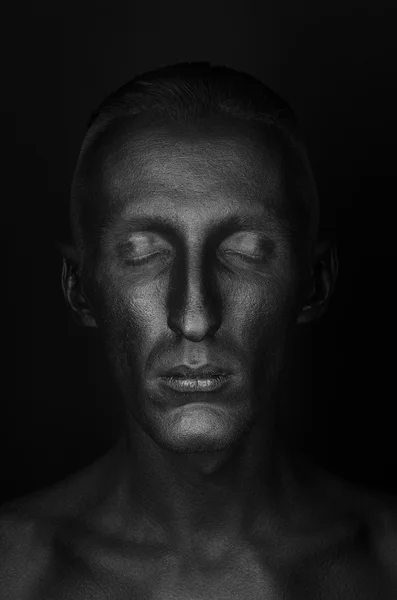 Gothic and Halloween theme: a man with black skin is isolated on a black background in the studio, the Black Death body art — Stock Photo, Image